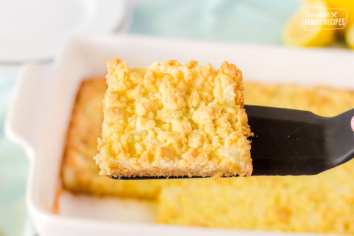 Spatula holding up a Lemon Cream Cheese Bar.