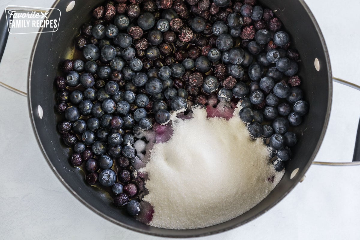 Blueberries and sugar in a large stock pot
