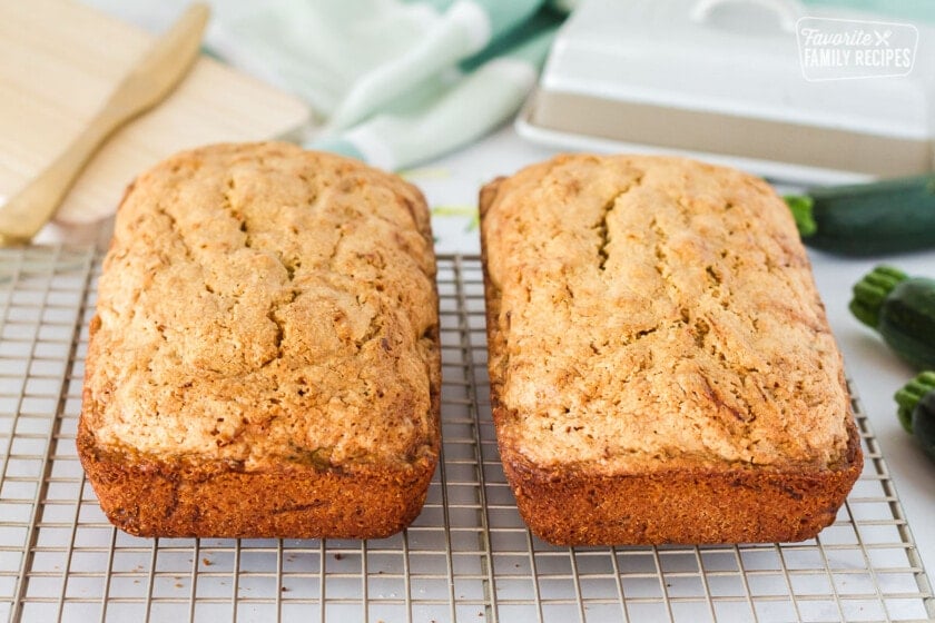 Two Mom's Zucchini Bread loaves cooling on wire rack.