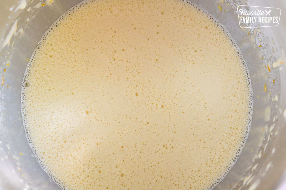Olive oil cake batter in a metal mixing bowl