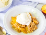 Scoop on ice cream on top of Summer Peach Crisp.
