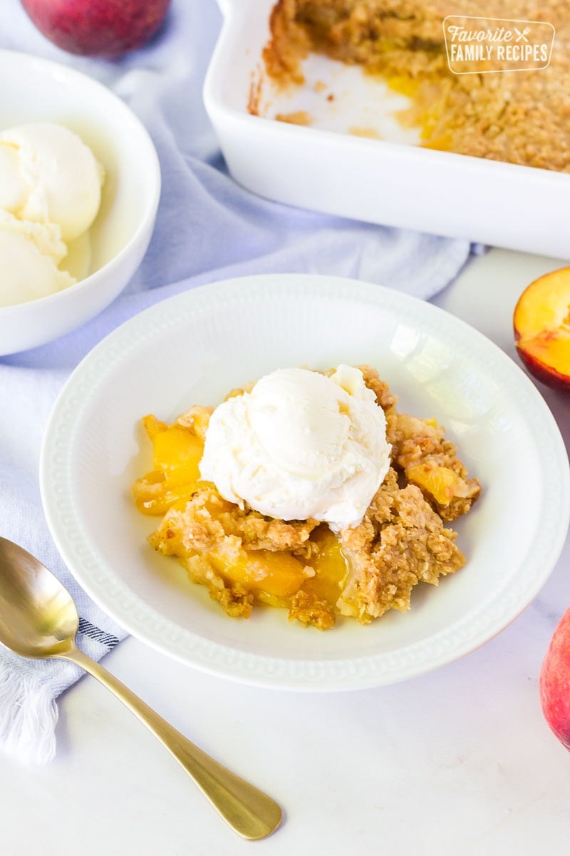 Scoop on ice cream on top of Summer Peach Crisp.