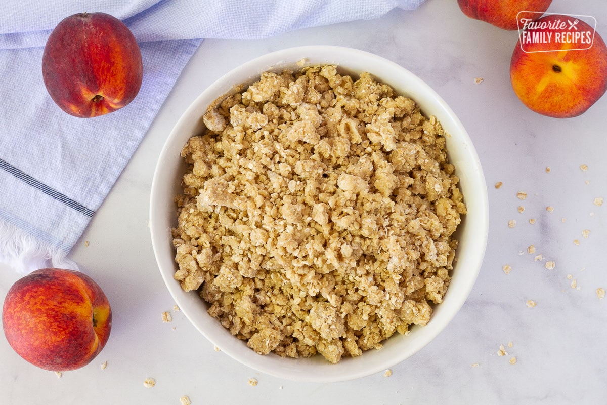 Crumb topping in a bowl for Summer Peach Crisp.