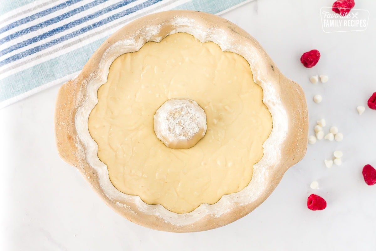 Batter at the bottom of a White Chocolate Raspberry Cake bundt pan.