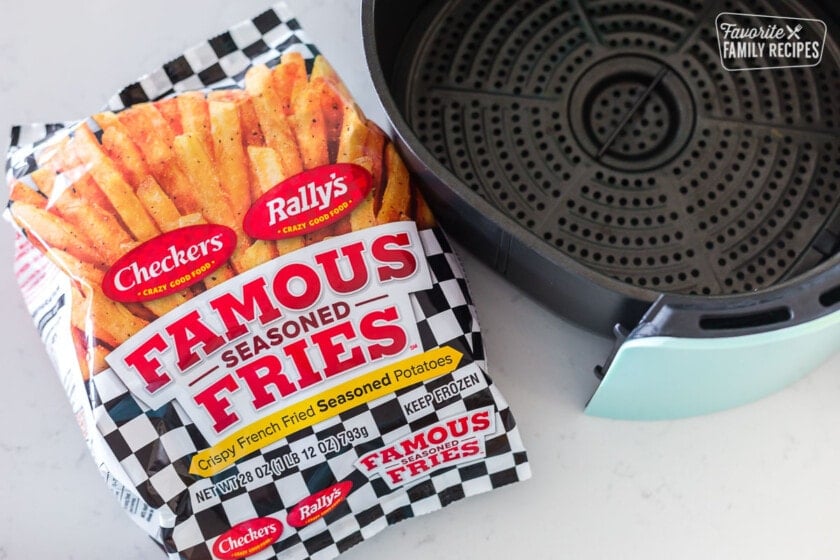A bag of frozen French fries next to an air fryer basket