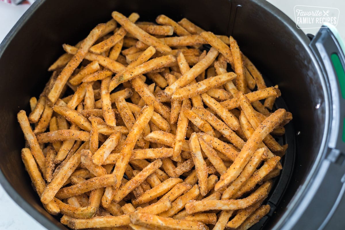 Frozen fries in an air fryer basket
