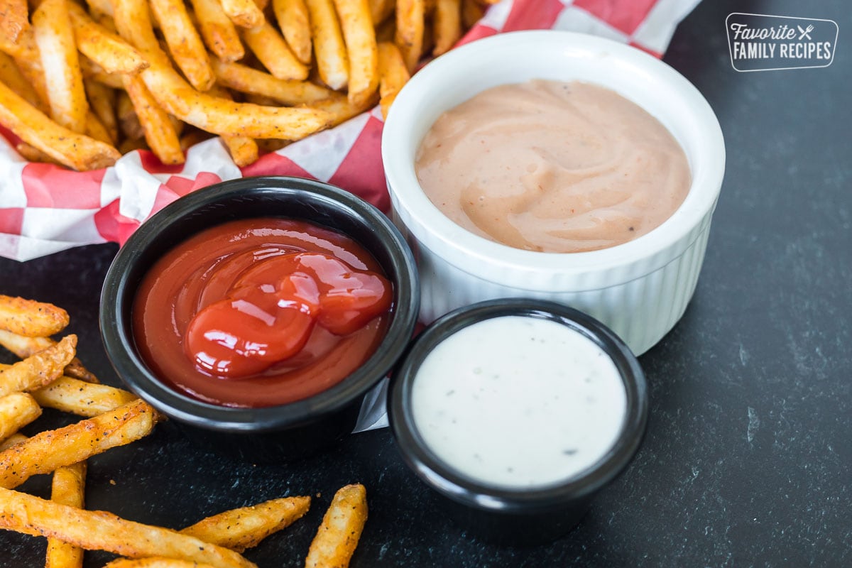 Ketchup, fry sauce, and ranch dressing for dipping French fries.