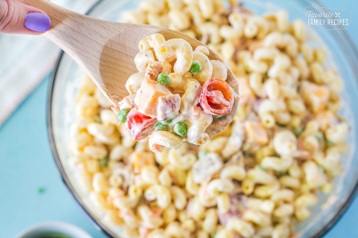 Top close up view of Bacon Ranch Pasta Salad on a wooden spoon.