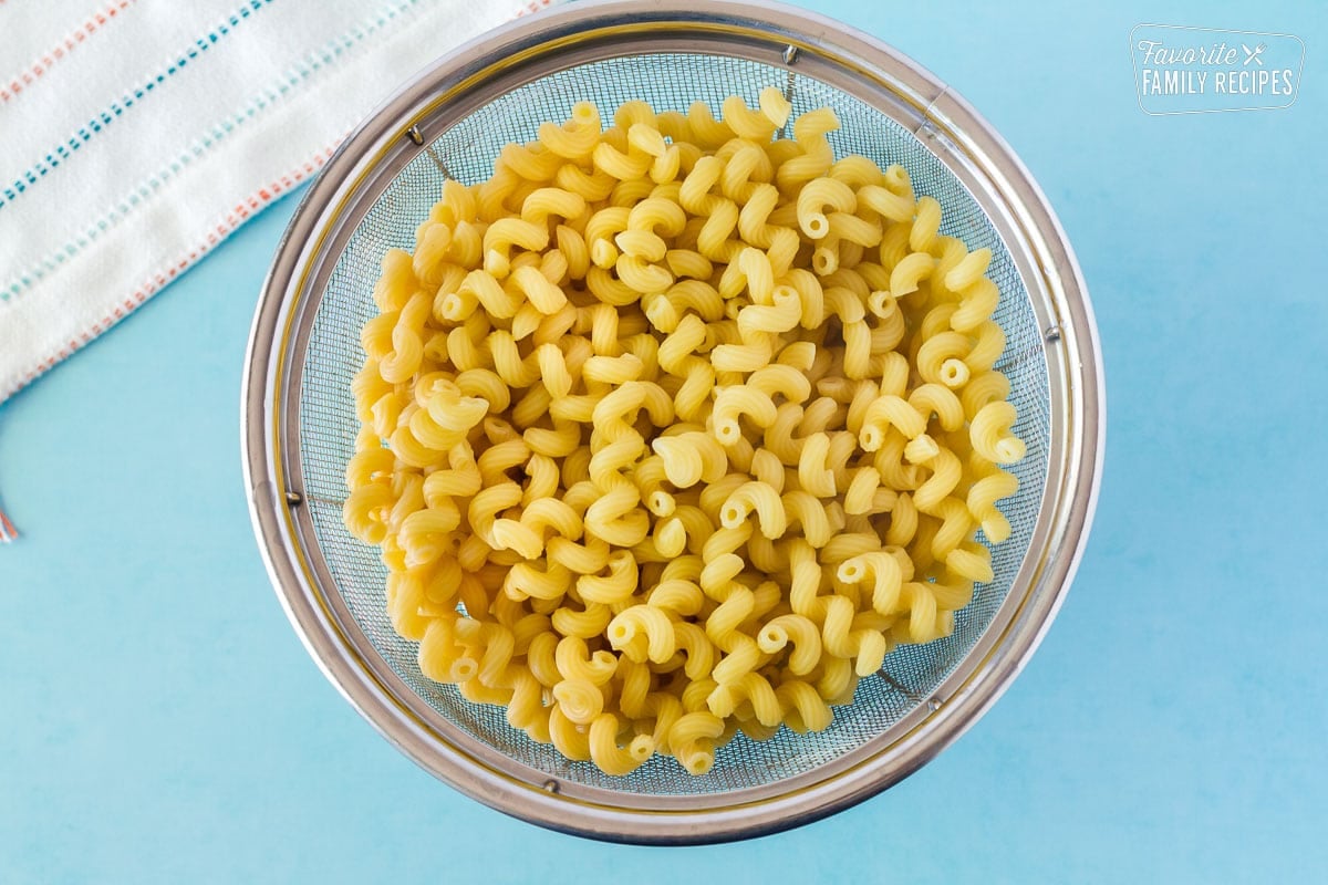 Cooked noodles in a colander for Bacon Ranch Pasta Salad.