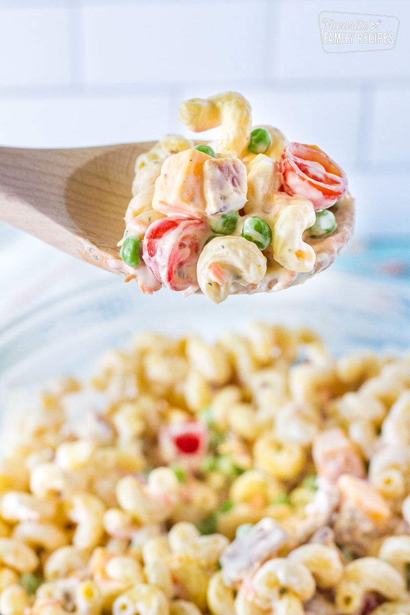 Close up of Bacon Ranch Pasta Salad on a wooden spoon.