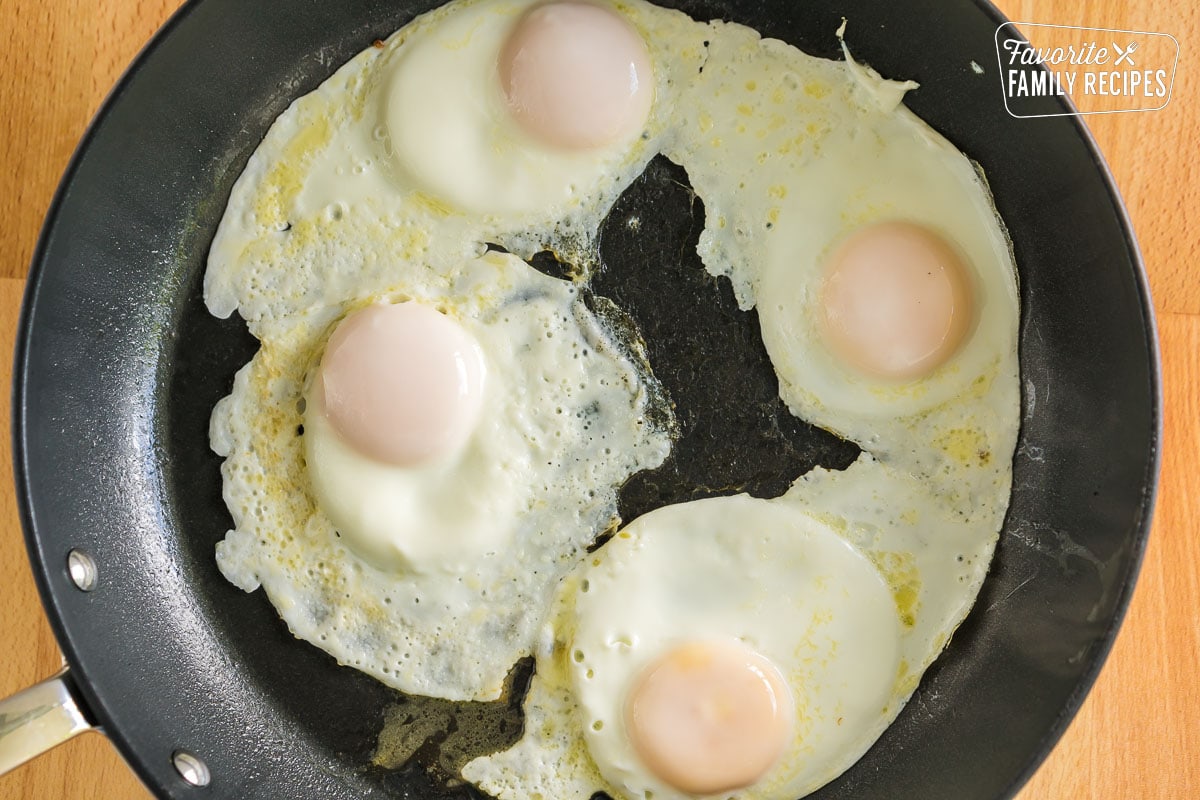 Four basted eggs in a skillet