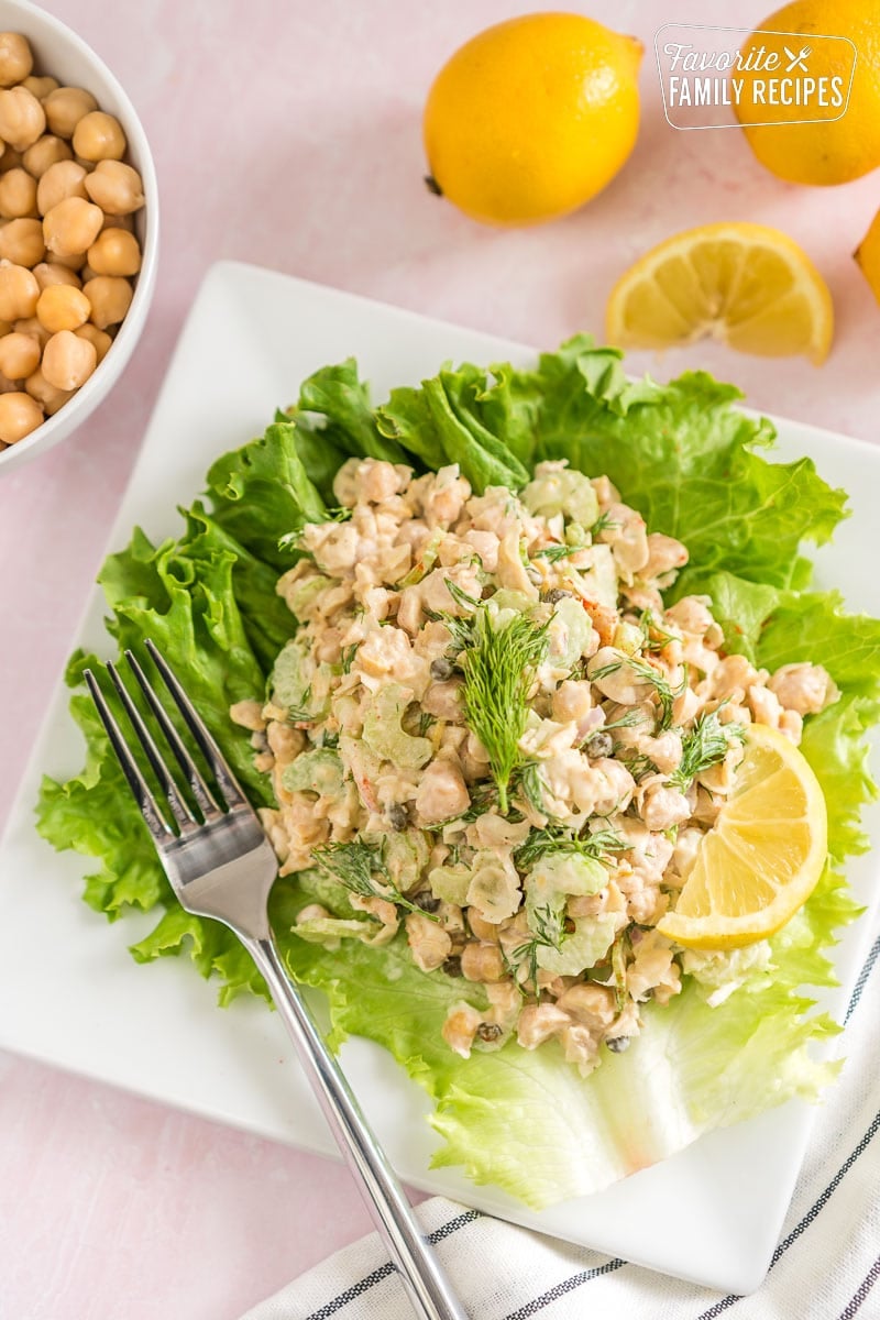 Chickpea salad on a lettuce leaf topped with fresh dill.