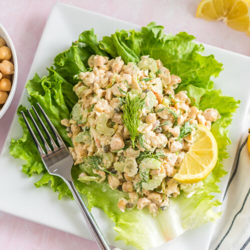 Chickpea salad on a lettuce leaf topped with fresh dill