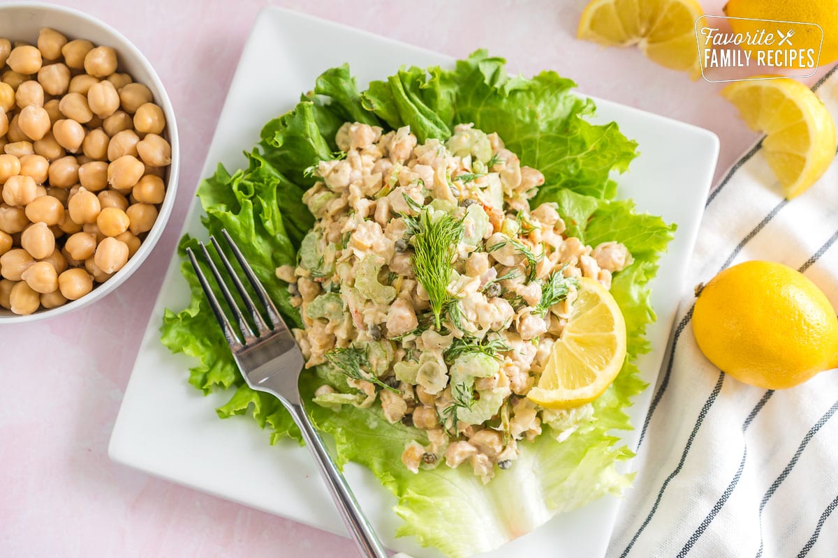Chickpea salad on a lettuce leaf topped with fresh dill
