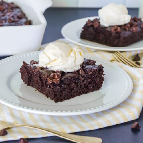 Two slices of Chocolate Pudding Cake topped with vanilla ice cream.