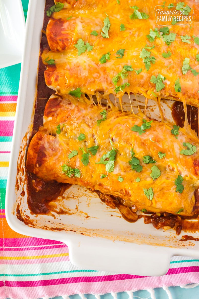 Enchiladas with Homemade Enchilada Sauce with the cheese stretched in a dish.