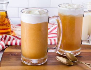 Side view of two tall mugs of Frozen Butterbeer.