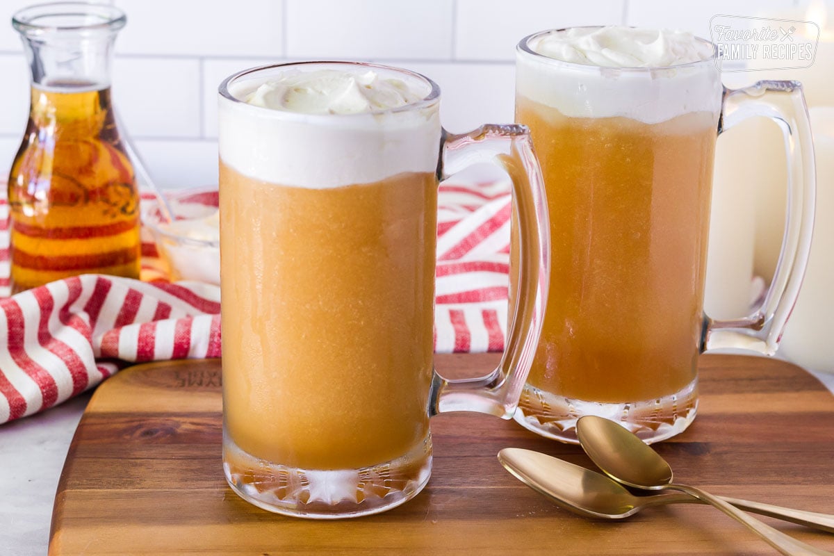 Side view of two tall mugs of Frozen Butterbeer.