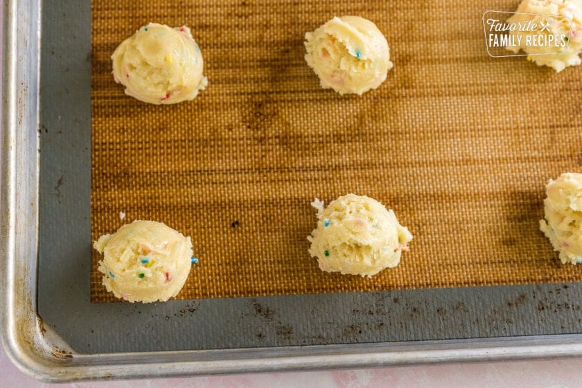 Cookie dough balls on a baking sheet