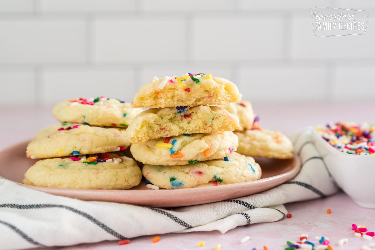 a funfetti cake mix cookie broken in half on a plate