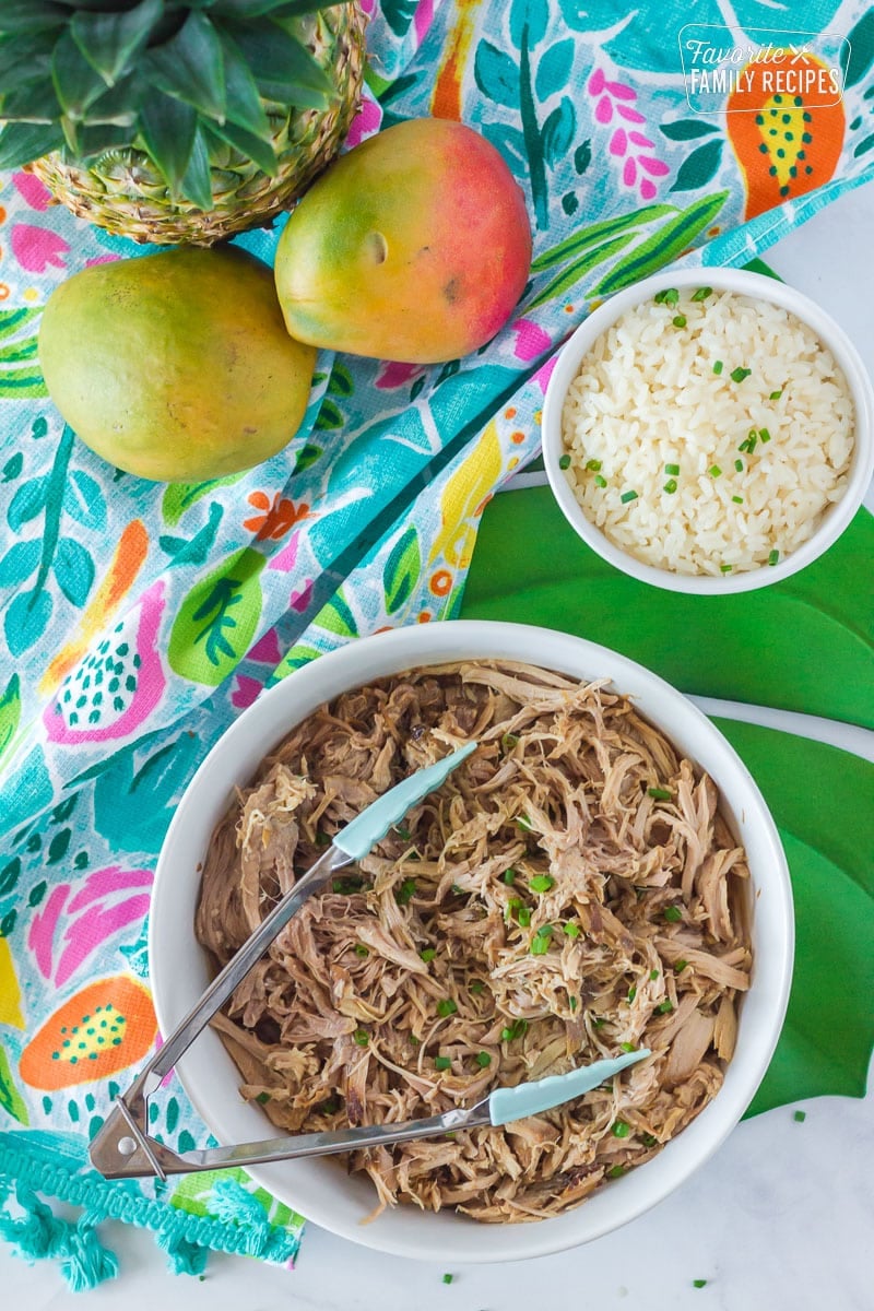 Kalua Pork in a serving dish topped with green onion.