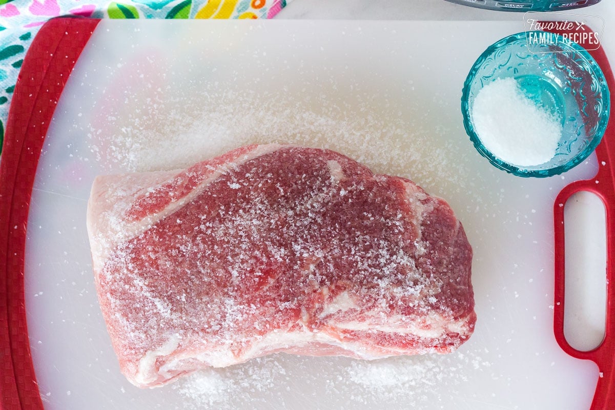 Kosher salt rubber all around uncooked pork roast.