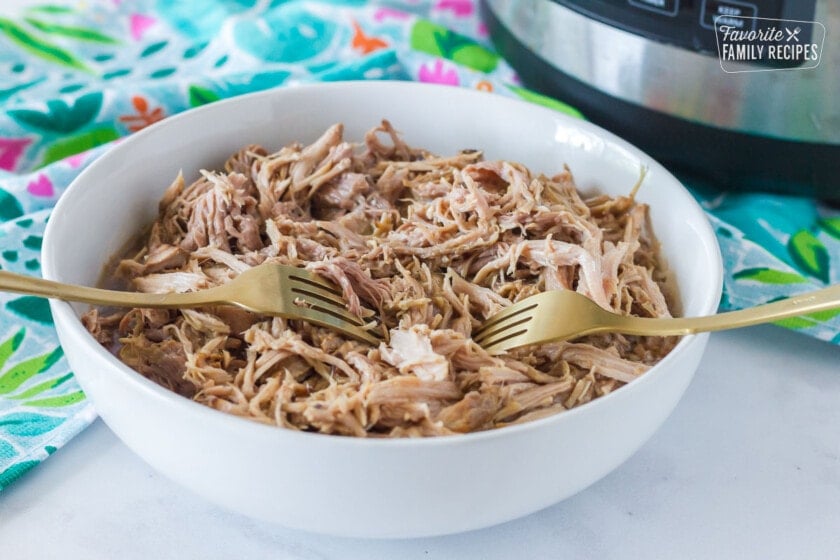 Shredding Kalua Pork with two forks.