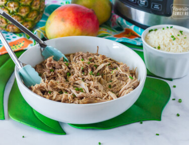 Kalua Pork in a serving dish with tongs.