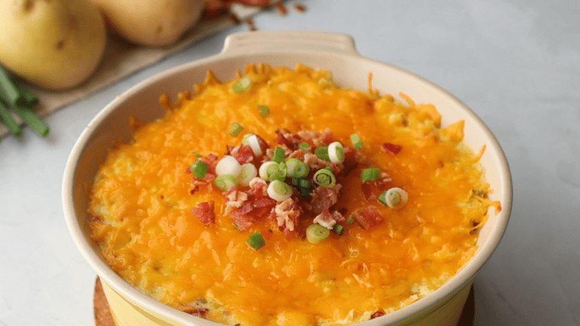 Baked Loaded Mashed Potatoes with bacon bits and onions on top
