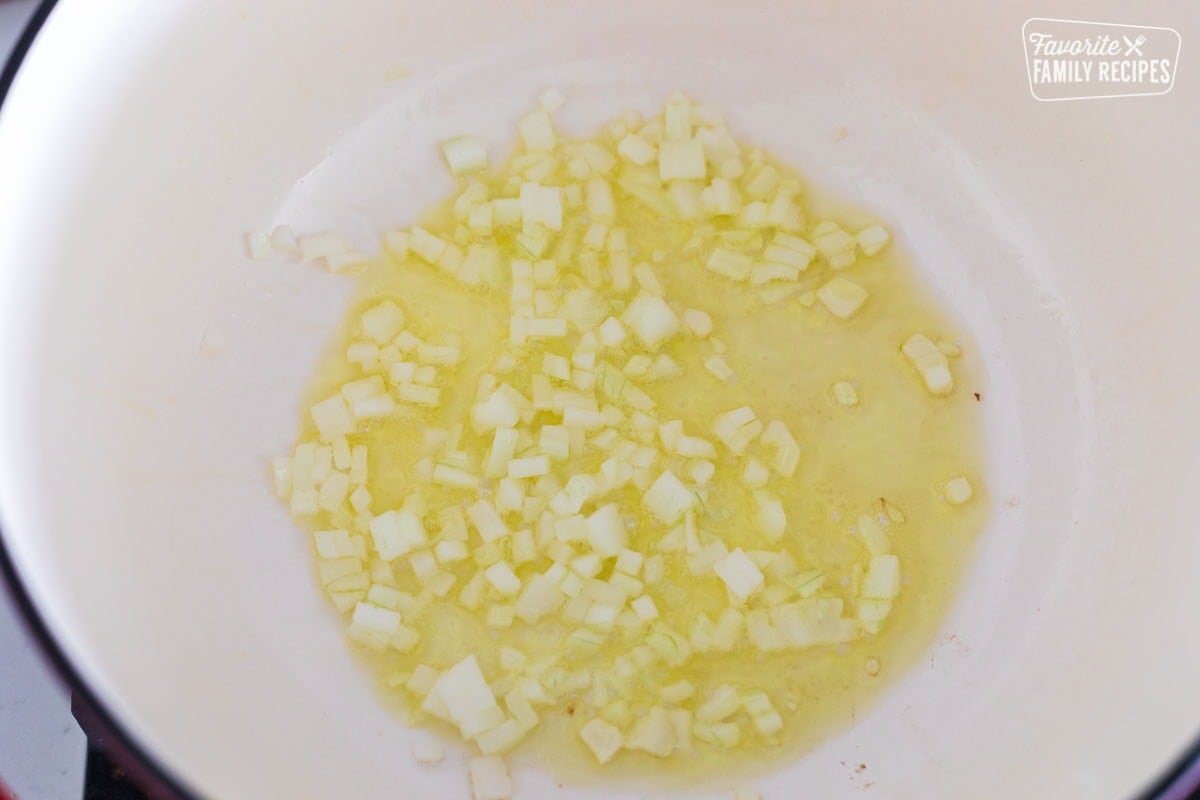 chopped onions sautéing in a Dutch oven