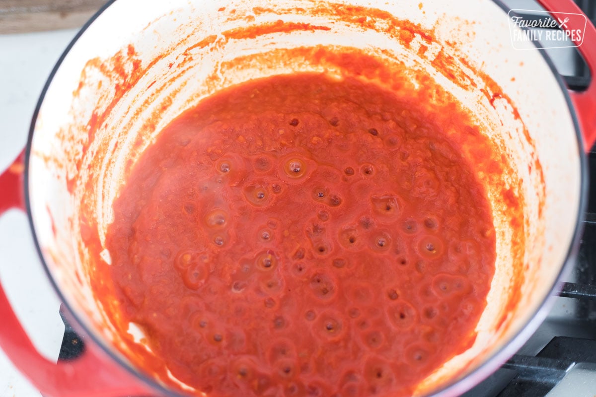 Crushed tomatoes simmering in a Dutch oven