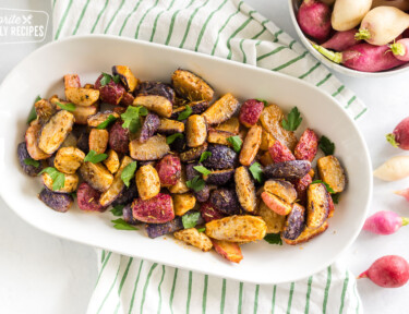 Roasted Radishes on a platter topped with parsley