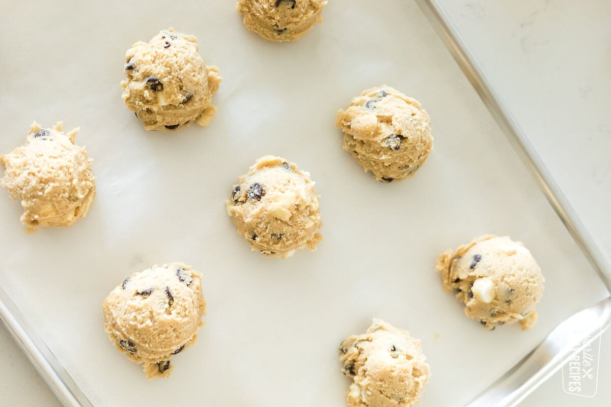 A baking sheet with balls of s'mores cookie dough
