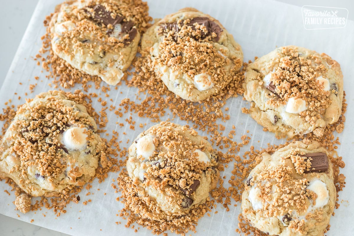 Enjoy your favorite summertime treat without a campfire! These s'mores cookies are packed with chocolate, marshmallows, and graham crackers. S'mores cookies baked on a baking sheet