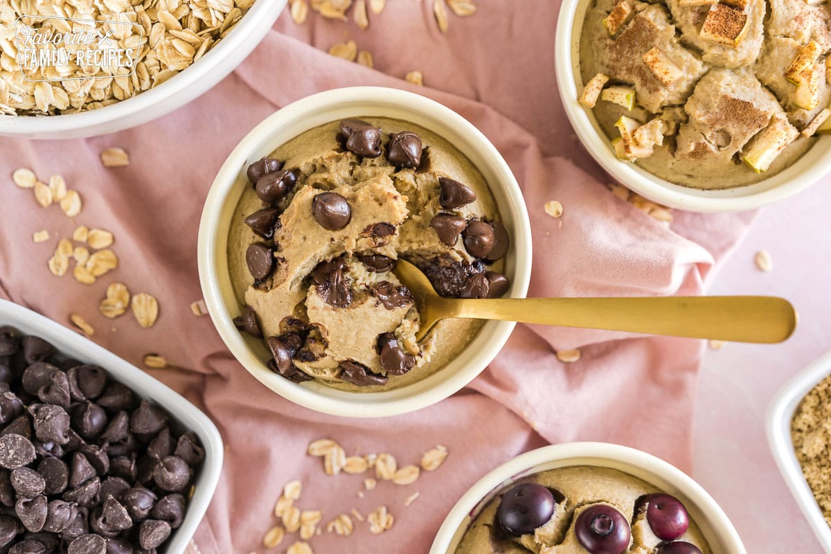 This baked oats recipe feels like eating dessert for breakfast, but with whole grains, eggs, and natural sweetness, they are healthy and filling! Chocolate chip baked oats with a spoon in them.