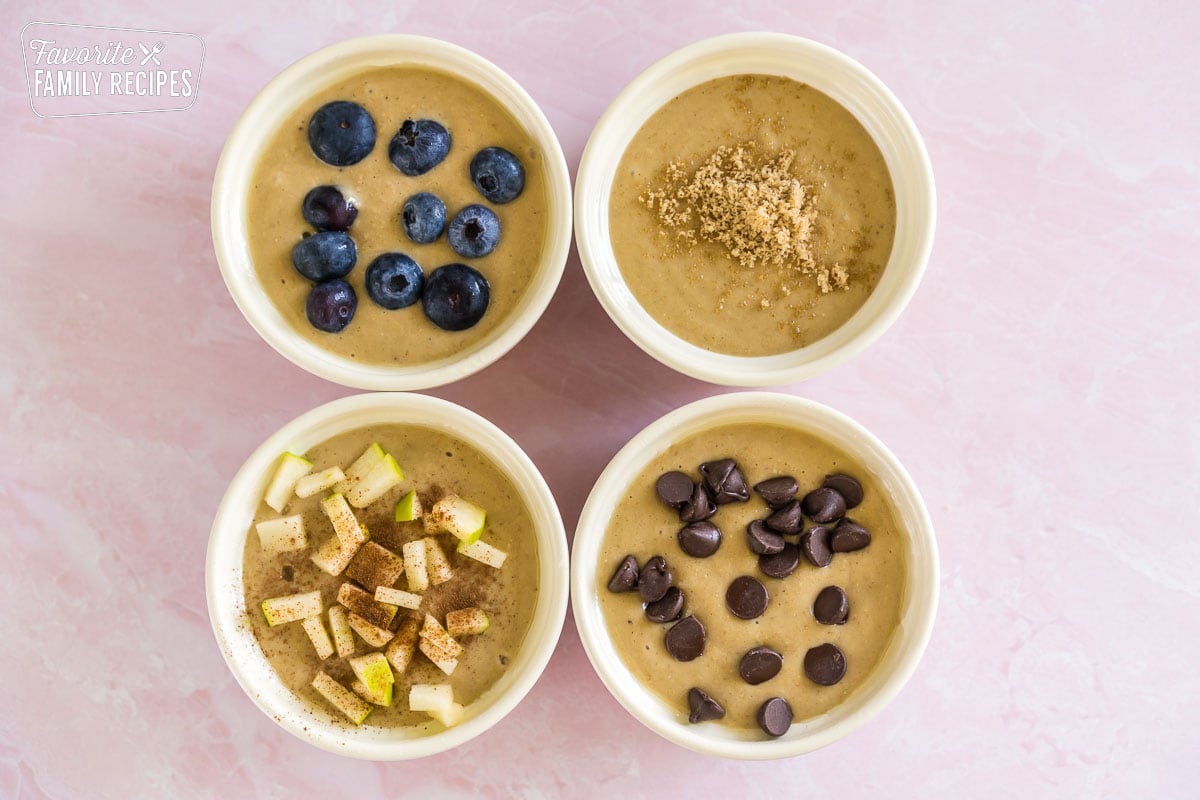 Baked oats in ramekins with toppings before they are baked.