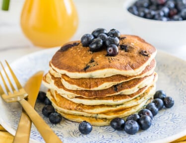 A stack of blueberry pancakes on a plate