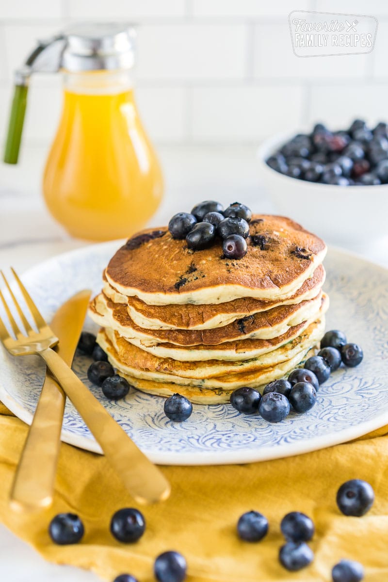 A stack of blueberry pancakes on a plate.