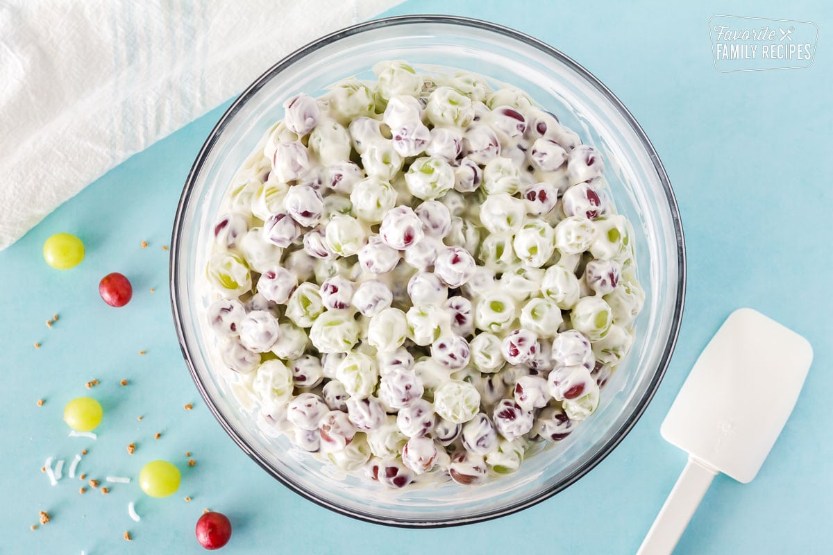 Bowl of grapes covered in the white cream cheese mixture to make Grape Salad.