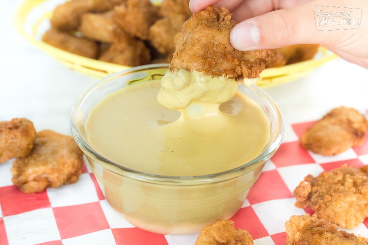 Our copycat Chick-Fil-A Sauce tastes like the real deal. So easy and only four ingredients! Chick-Fil-A Sauce with chicken nuggets