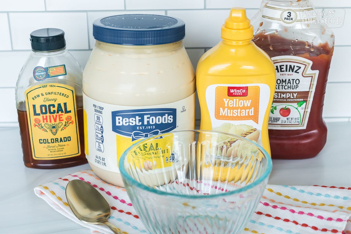 Ingredients to make Chick-Fil-A sauce including mayonnaise, mustard, ketchup, and honey.