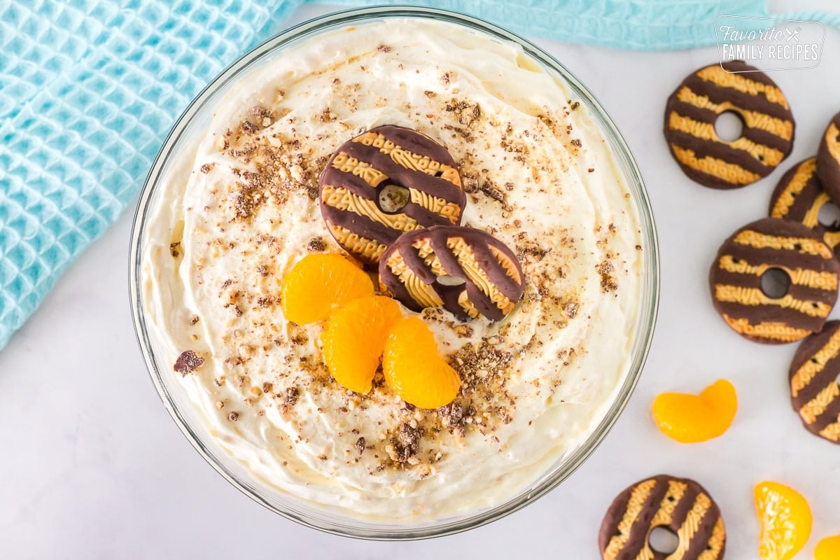 Bowl of finished Fudge Stripe Cookies. Fudge striped cookies and mandarin oranges on top.