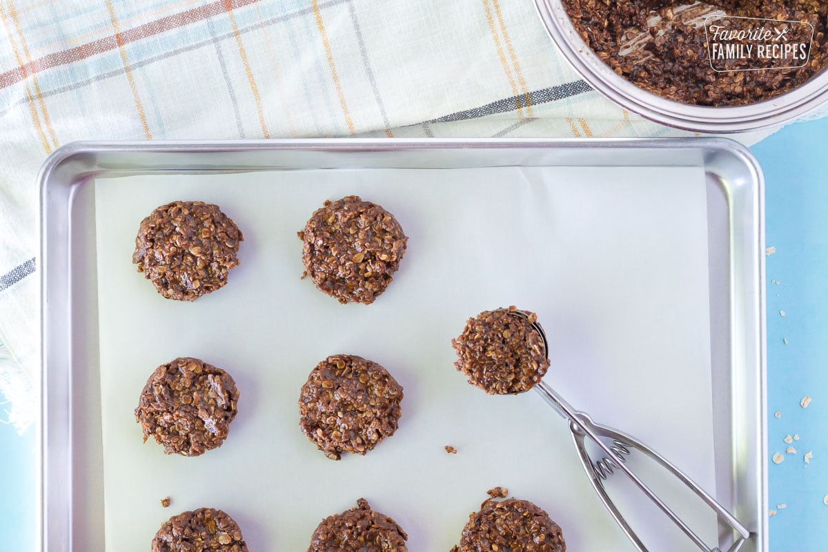 Cookie scoop on a cookie sheet with fresh No Bake Cookies.