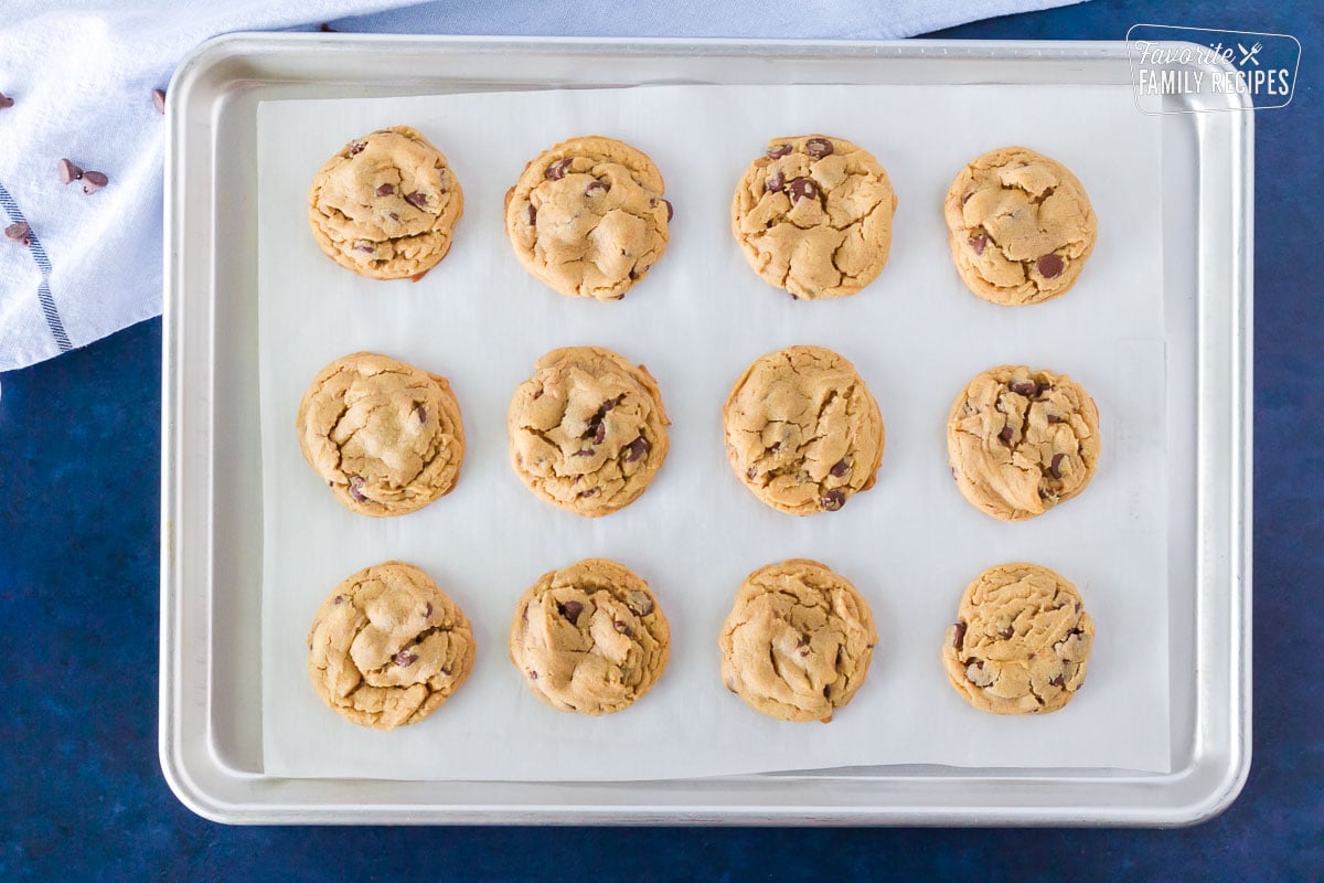Cookie sheet of twelve baked Peanut Butter Chocolate Chip Cookies.