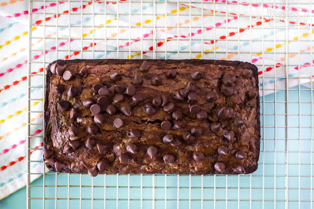Chocolate Banana Bread on a cooling rack sprinkled with chocolate chips.