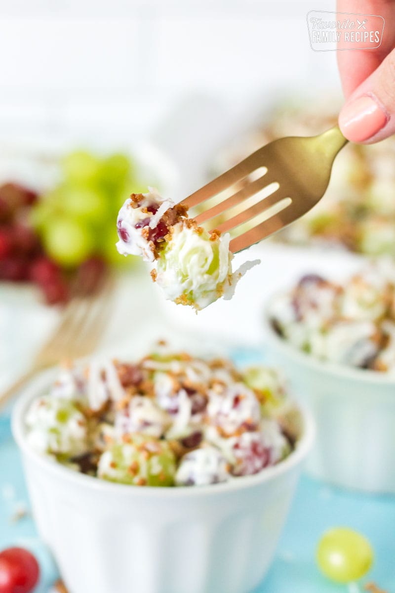 Fork stabbing two Grape Salad grapes.