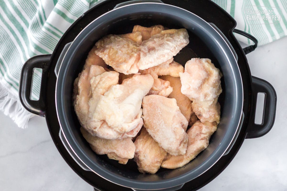Slow Cooker with frozen chicken wings for Hot Wings with Blue Cheese Dressing.