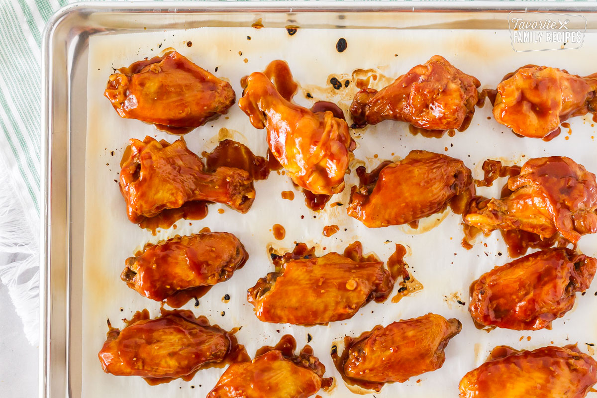 Cookie sheet with saucy prepared hot wings for Hot Wings with Blue Cheese Dressing.
