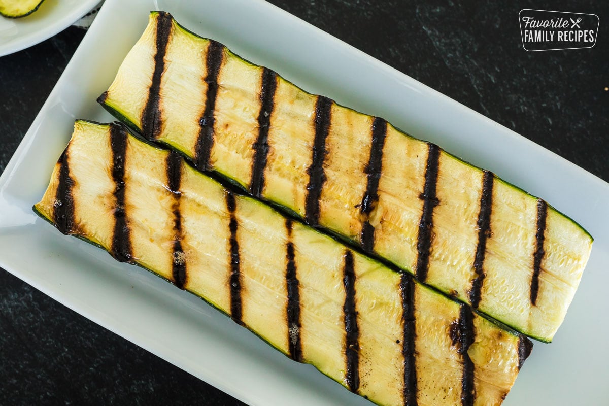 A zucchini sliced in half and grilled.