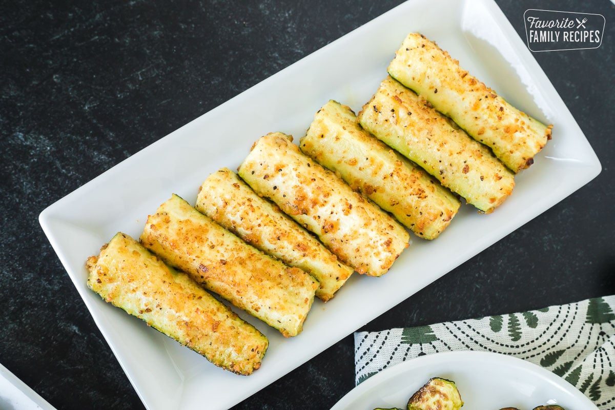 Roasted zucchini spears on a serving platter.